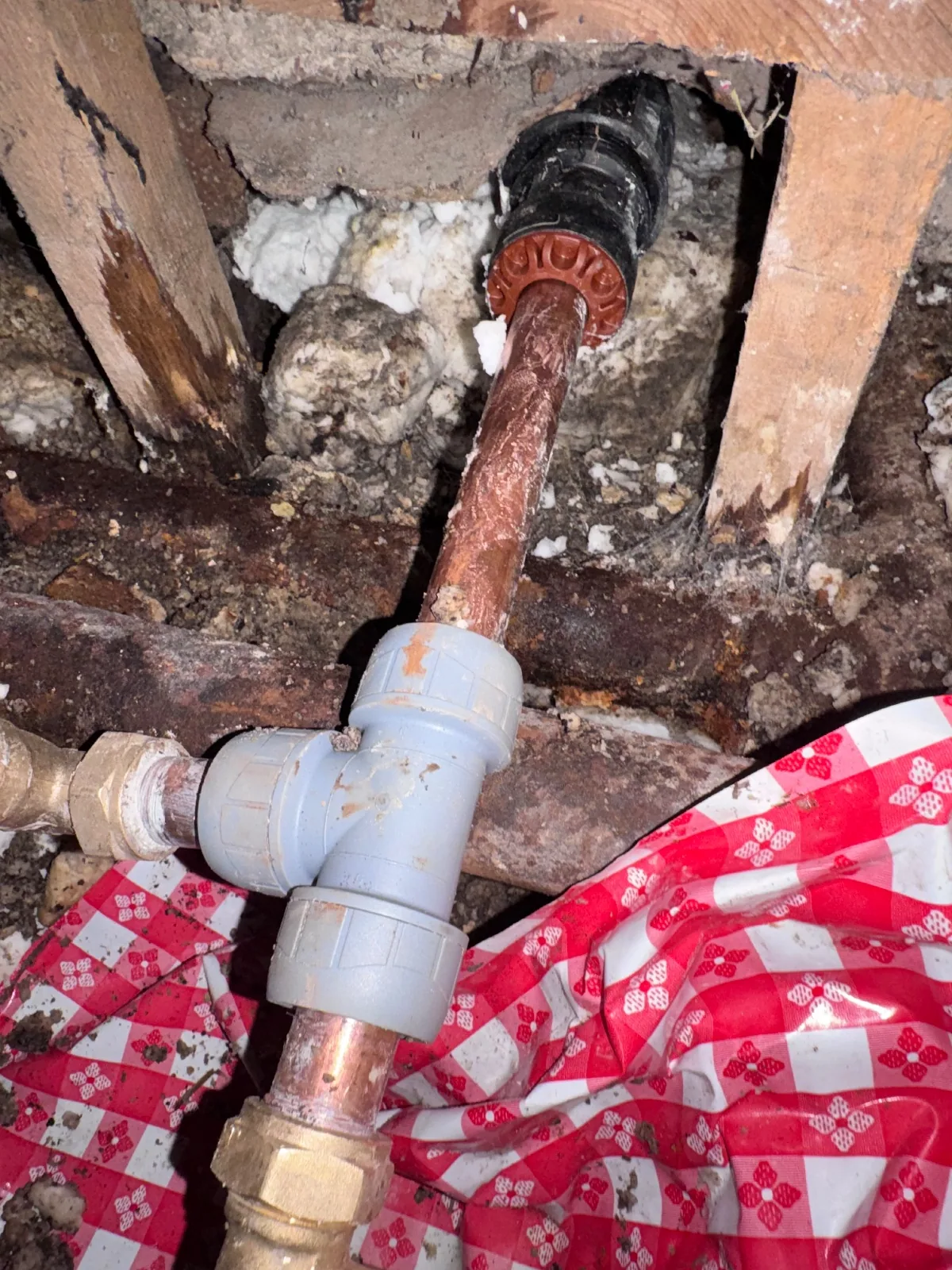 Leaking joint reached and repaired beneath lifted floorboards